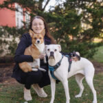 Deanna pictured outside with a corgi and boxer