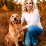 Dr. Beck with a golden retriever smiling