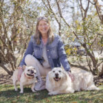 Dr. Bruce outside with a frenchie and yellow lab