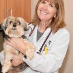 Heather holding a terrier and smiling